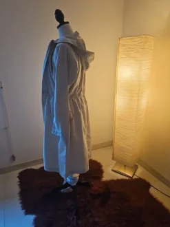 beigen Damen-Regenmantel bzw. Parka mit Kapuze und Taillenzug.